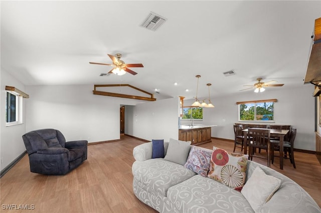 8625 Redwood Dr, Saint James City, FL 33956 - living room with ceiling fan, baseboards, light wood finished floors, and lofted ceiling