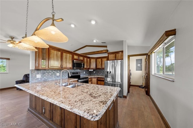 8625 Redwood Dr, Saint James City, FL 33956 - kitchen featuring appliances with stainless steel finishes, a peninsula, lofted ceiling, baseboards, and decorative backsplash