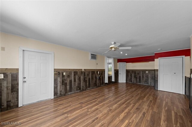 8625 Redwood Dr, Saint James City, FL 33956 - unfurnished living room with ceiling fan, a wainscoted wall, wood finished floors, and wooden walls