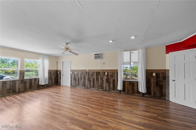 8625 Redwood Dr, Saint James City, FL 33956 - unfurnished living room featuring wood finished floors, wainscoting, a ceiling fan, wooden walls, and recessed lighting
