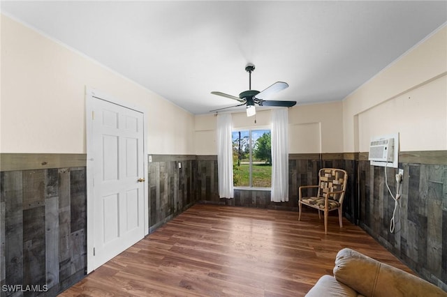 8625 Redwood Dr, Saint James City, FL 33956 - sitting room with wood finished floors, wainscoting, a wall mounted air conditioner, and ceiling fan