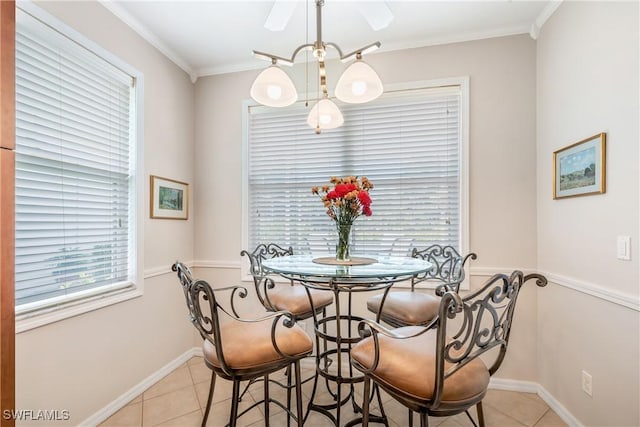 dining space featuring light tile patterned flooring, baseboards, a chandelier, and crown molding