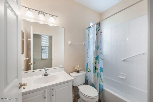 bathroom with vanity, shower / bath combination with curtain, and toilet