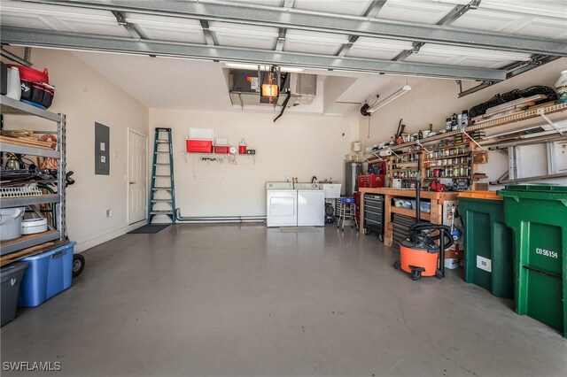 garage with washing machine and dryer, water heater, electric panel, and a garage door opener