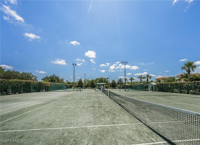 view of tennis court featuring fence