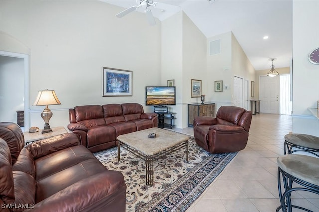 living room featuring high vaulted ceiling, light tile patterned flooring, and ceiling fan