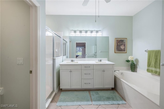 bathroom with double vanity, a stall shower, a garden tub, and tile patterned floors