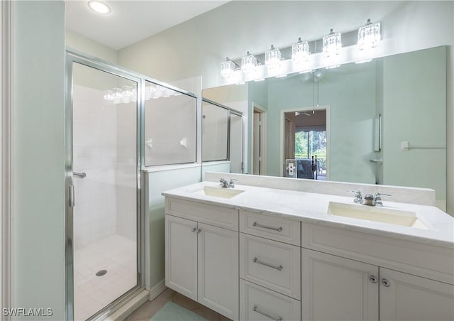 full bathroom with a shower stall, double vanity, and recessed lighting