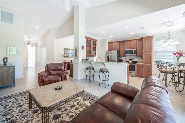 living room with light tile patterned flooring, recessed lighting, lofted ceiling, and baseboards