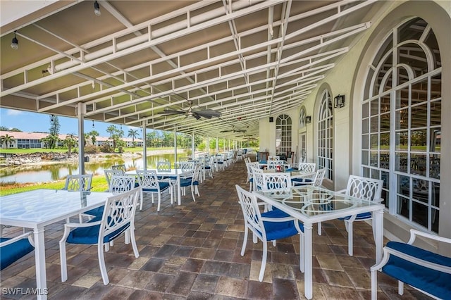 view of patio with outdoor dining space and a water view