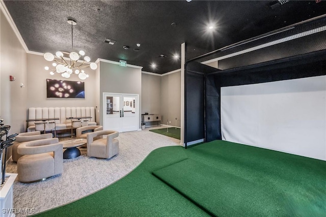 home theater room featuring golf simulator, ornamental molding, carpet floors, and a chandelier
