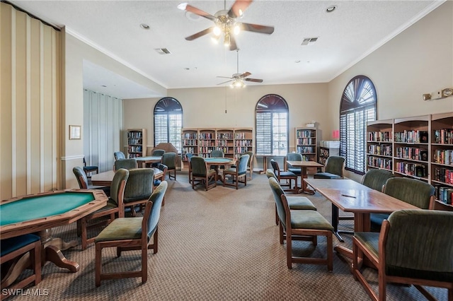 dining area featuring carpet floors, ceiling fan, plenty of natural light, and ornamental molding