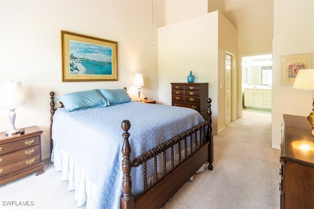917 Fairhaven Ct Unit 29, Naples, FL 34104 - bedroom with light carpet, connected bathroom, baseboards, and a towering ceiling