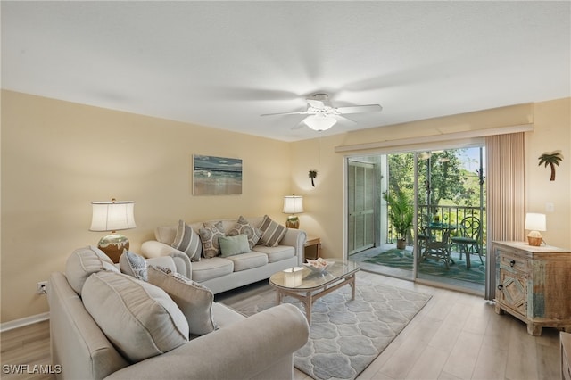 living room with ceiling fan, light wood-type flooring, and baseboards