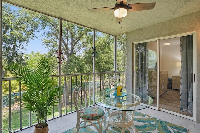 sunroom featuring a ceiling fan