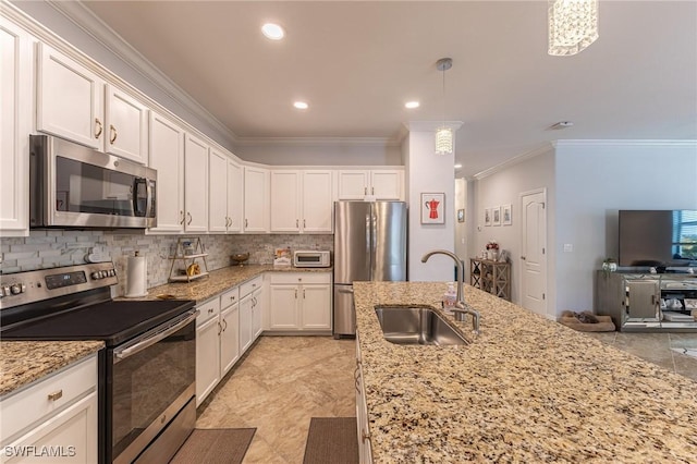 9231 Shadow Oak Ln, Naples, FL 34120 - kitchen with a sink, ornamental molding, backsplash, white cabinets, and appliances with stainless steel finishes