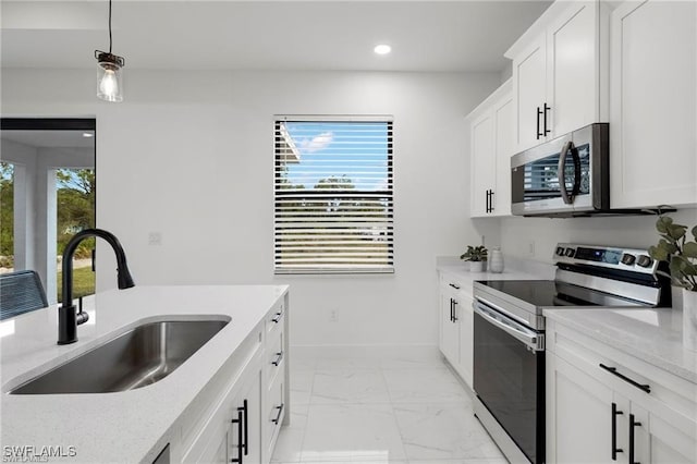 kitchen with stainless steel appliances, a sink, light marble finish floors, recessed lighting, and light stone counters