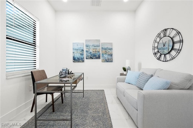 living room featuring light marble finish flooring and baseboards