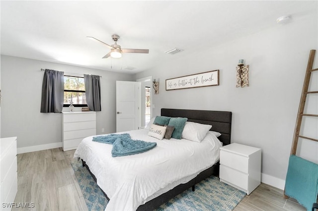 bedroom featuring light wood-type flooring, baseboards, and ceiling fan
