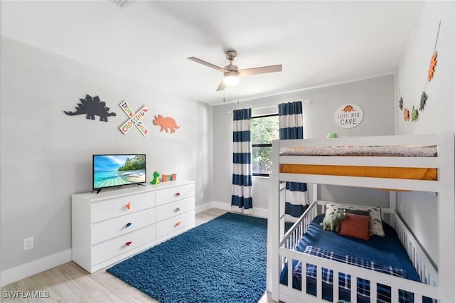 bedroom featuring wood finished floors, baseboards, and ceiling fan