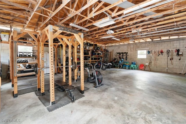 misc room featuring concrete flooring and concrete block wall
