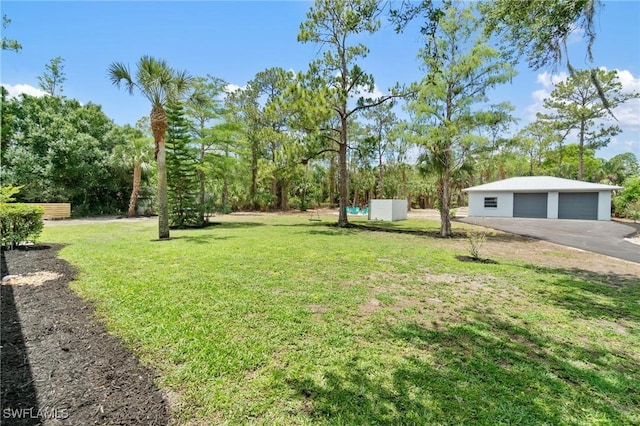 view of grassy yard with a detached garage