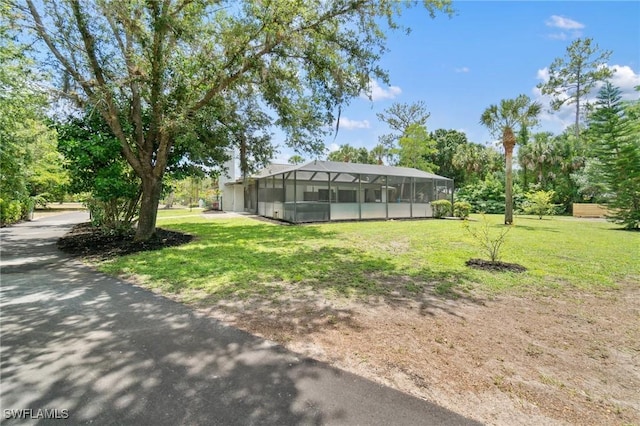 view of green lawn with glass enclosure