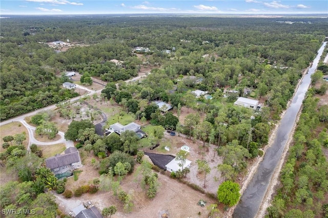 aerial view of property and surrounding area with a forest