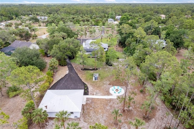 aerial view of property and surrounding area with a forest