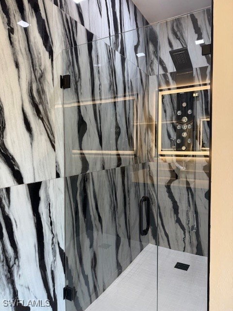 bathroom with a marble finish shower