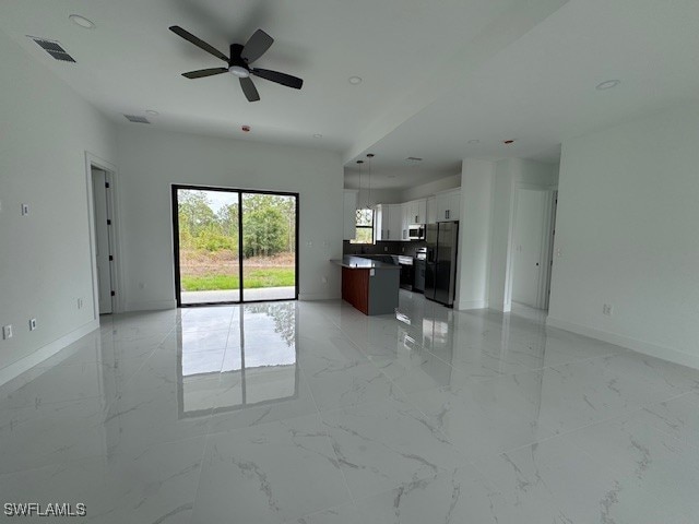 unfurnished living room with visible vents and marble finish floor
