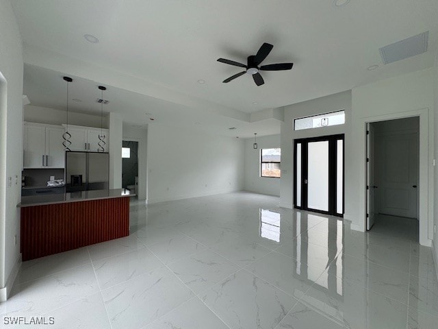 unfurnished living room with visible vents, marble finish floor, and a ceiling fan