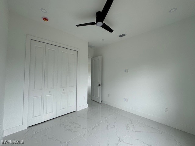 unfurnished bedroom with a ceiling fan, a closet, visible vents, baseboards, and marble finish floor