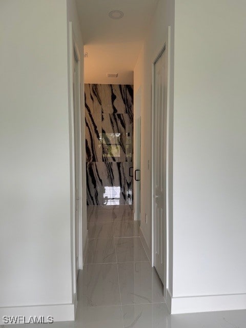 hall with marble finish floor