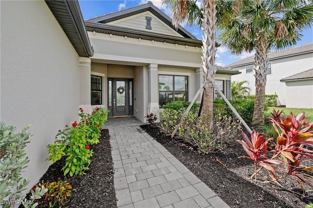 view of exterior entry with stucco siding