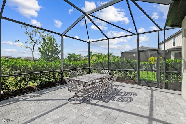 view of patio / terrace featuring outdoor dining space and a lanai