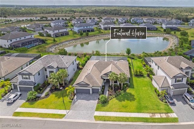 birds eye view of property featuring a water view and a residential view