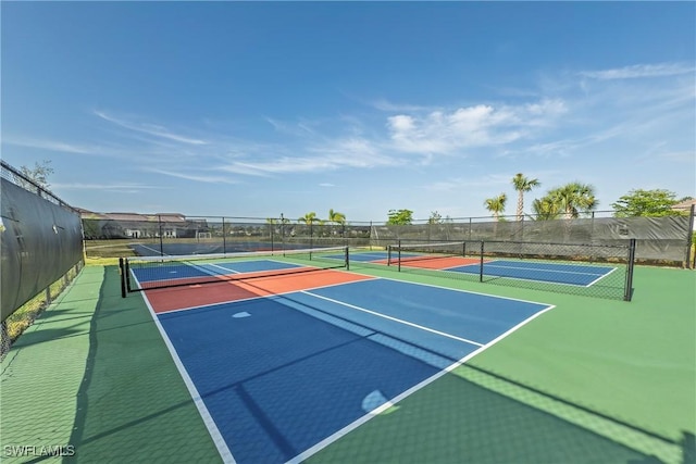 view of tennis court featuring fence
