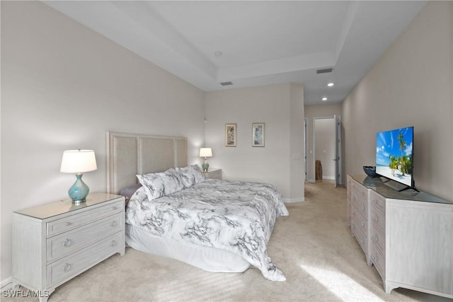 bedroom featuring visible vents, recessed lighting, light carpet, a tray ceiling, and baseboards