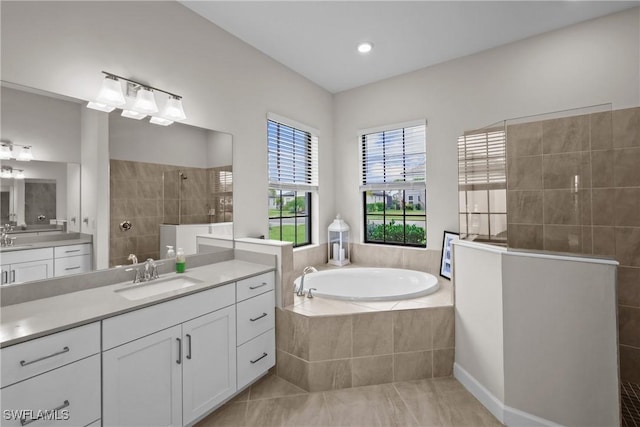 full bath with a bath, a sink, a walk in shower, tile patterned flooring, and two vanities