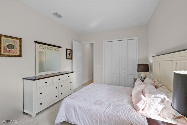 bedroom with light carpet, a closet, and visible vents