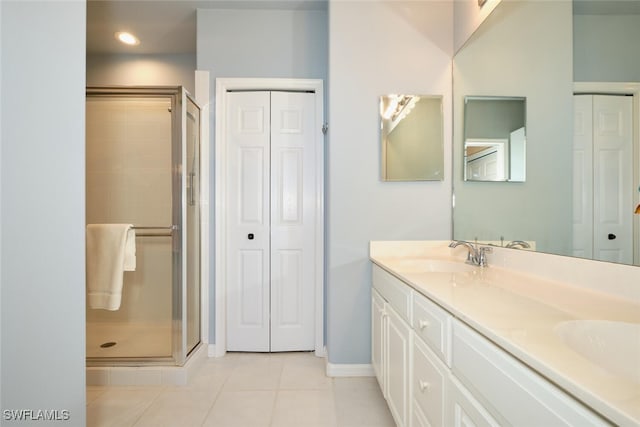 17110 Bridgestone Ct Unit 303, Fort Myers, FL 33908 - bathroom featuring double vanity, a sink, a closet, tile patterned flooring, and a shower stall