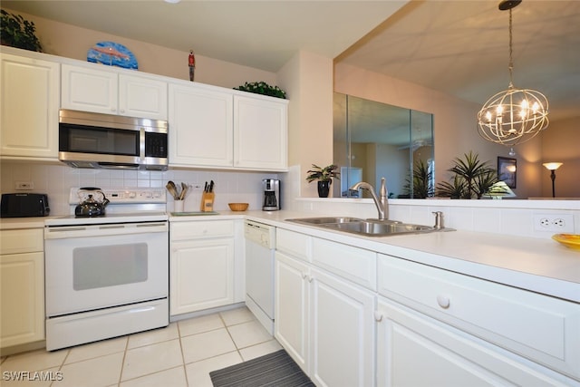 17110 Bridgestone Ct Unit 303, Fort Myers, FL 33908 - kitchen with a sink, white appliances, a chandelier, light countertops, and light tile patterned floors