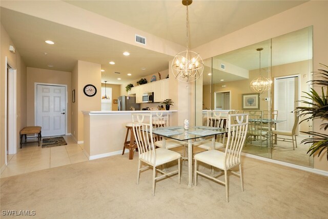 17110 Bridgestone Ct Unit 303, Fort Myers, FL 33908 - dining space featuring a notable chandelier, recessed lighting, baseboards, visible vents, and light colored carpet