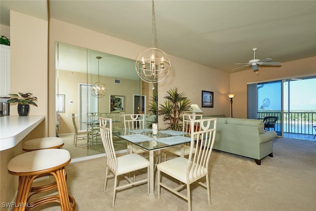17110 Bridgestone Ct Unit 303, Fort Myers, FL 33908 - dining area with light colored carpet, visible vents, and ceiling fan with notable chandelier