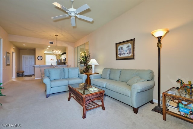 17110 Bridgestone Ct Unit 303, Fort Myers, FL 33908 - living area with light carpet, baseboards, ceiling fan with notable chandelier, and visible vents