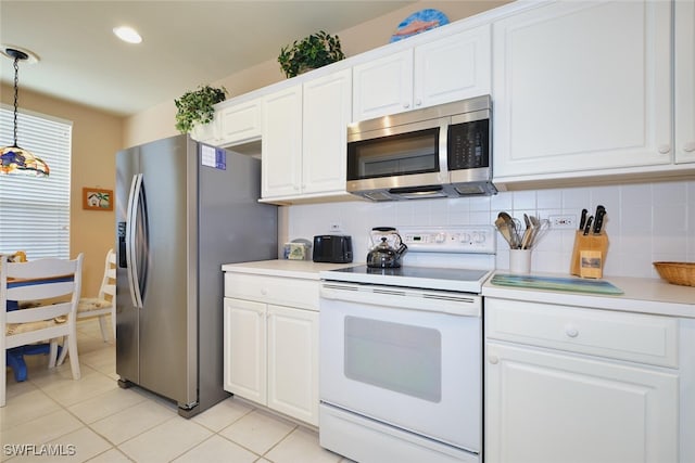 17110 Bridgestone Ct Unit 303, Fort Myers, FL 33908 - kitchen featuring decorative backsplash, light countertops, light tile patterned floors, and appliances with stainless steel finishes