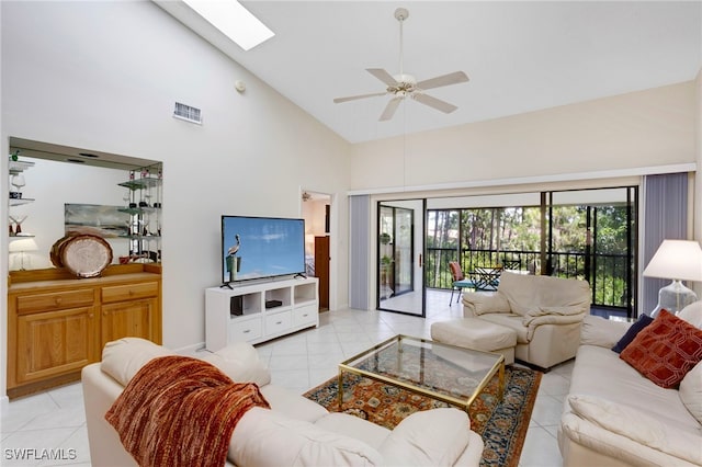 15400 Cedarwood Ln Unit 204, Naples, FL 34110 - living room featuring light tile patterned flooring, high vaulted ceiling, a ceiling fan, and a skylight