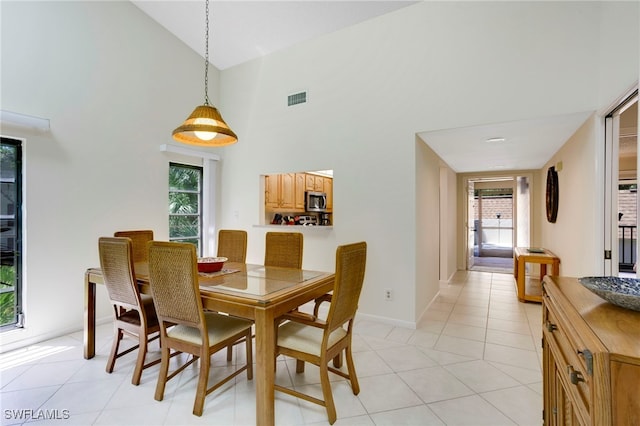 15400 Cedarwood Ln Unit 204, Naples, FL 34110 - dining space featuring high vaulted ceiling, plenty of natural light, baseboards, and light tile patterned floors