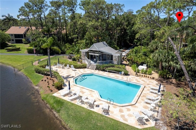 15400 Cedarwood Ln Unit 204, Naples, FL 34110 - community pool featuring a patio area, a water view, an outdoor structure, and view of wooded area